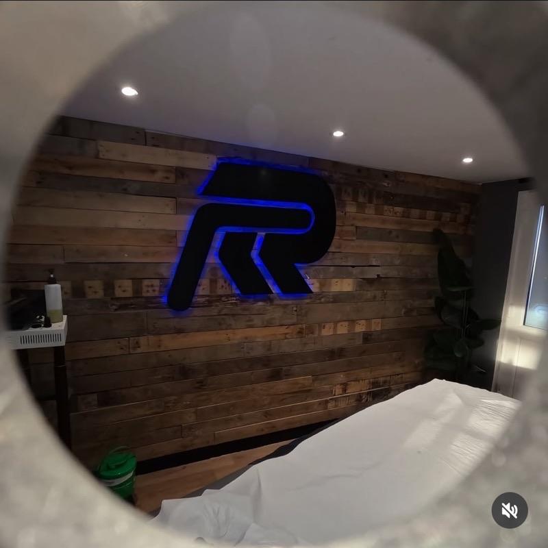 RnR Body Therapy treatment room with illuminated logo